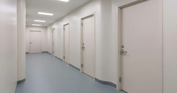 Behavioral health unit corridor with anti-ligature door hardware and rounded corner design features