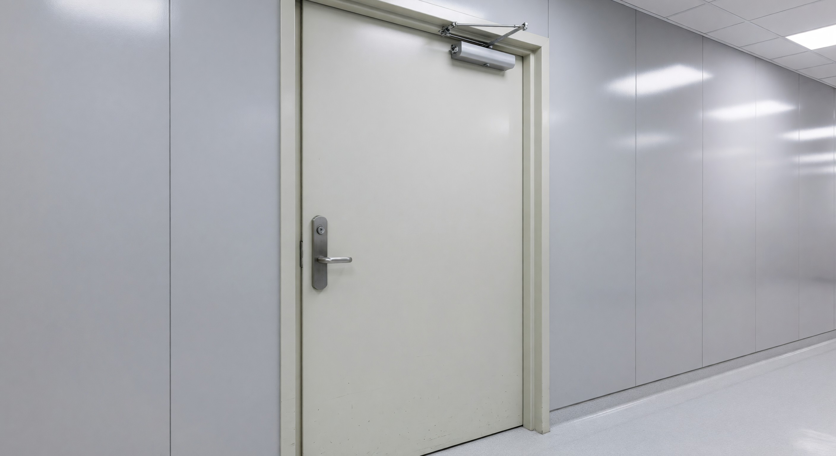 Hospital corridor door with antimicrobial lever hardware and automatic closer mechanism