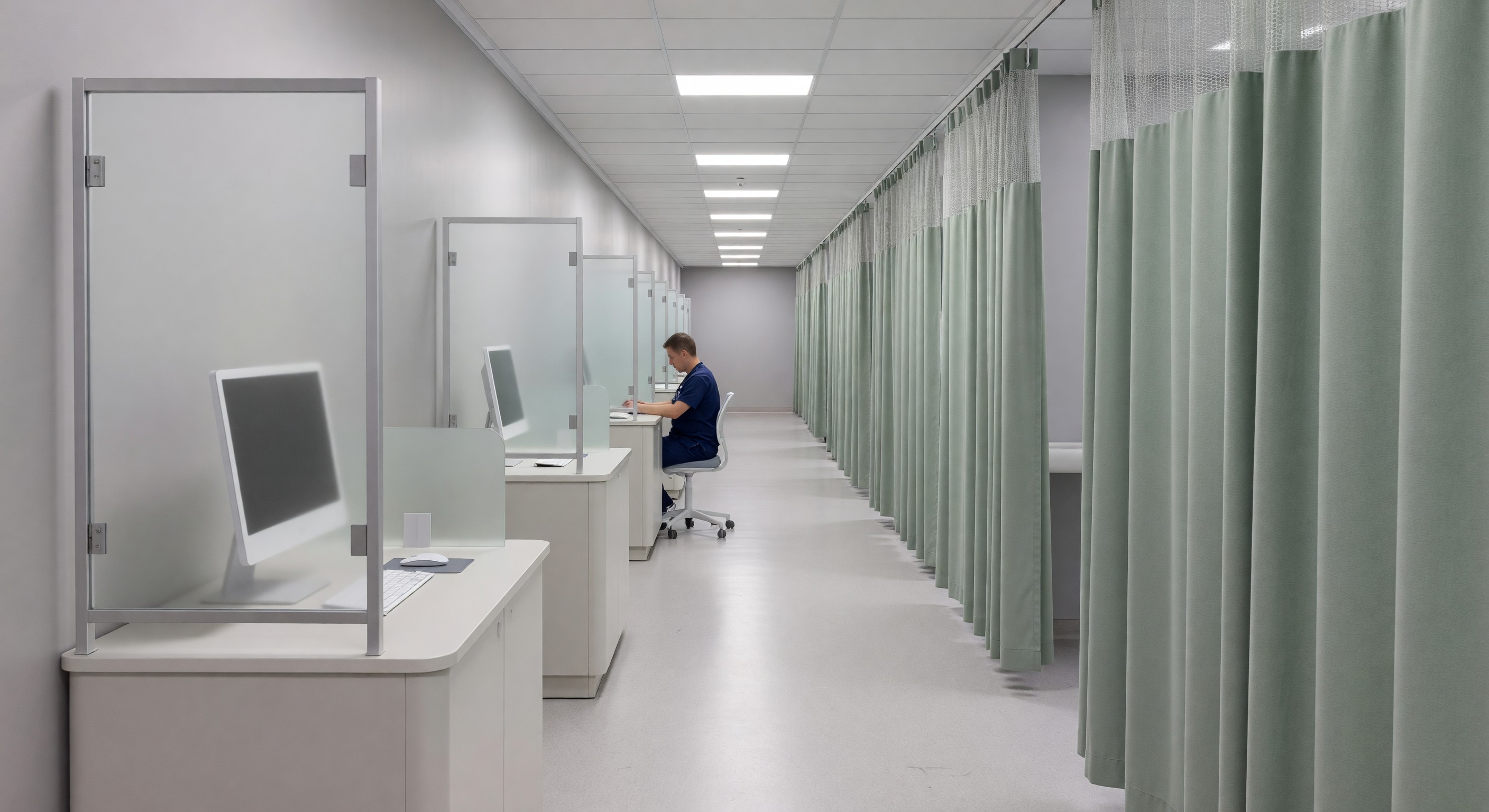 Healthcare facility hallway showing workstation placement and physical privacy controls