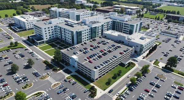 Aerial view of hospital campus with parking structure and surface lots