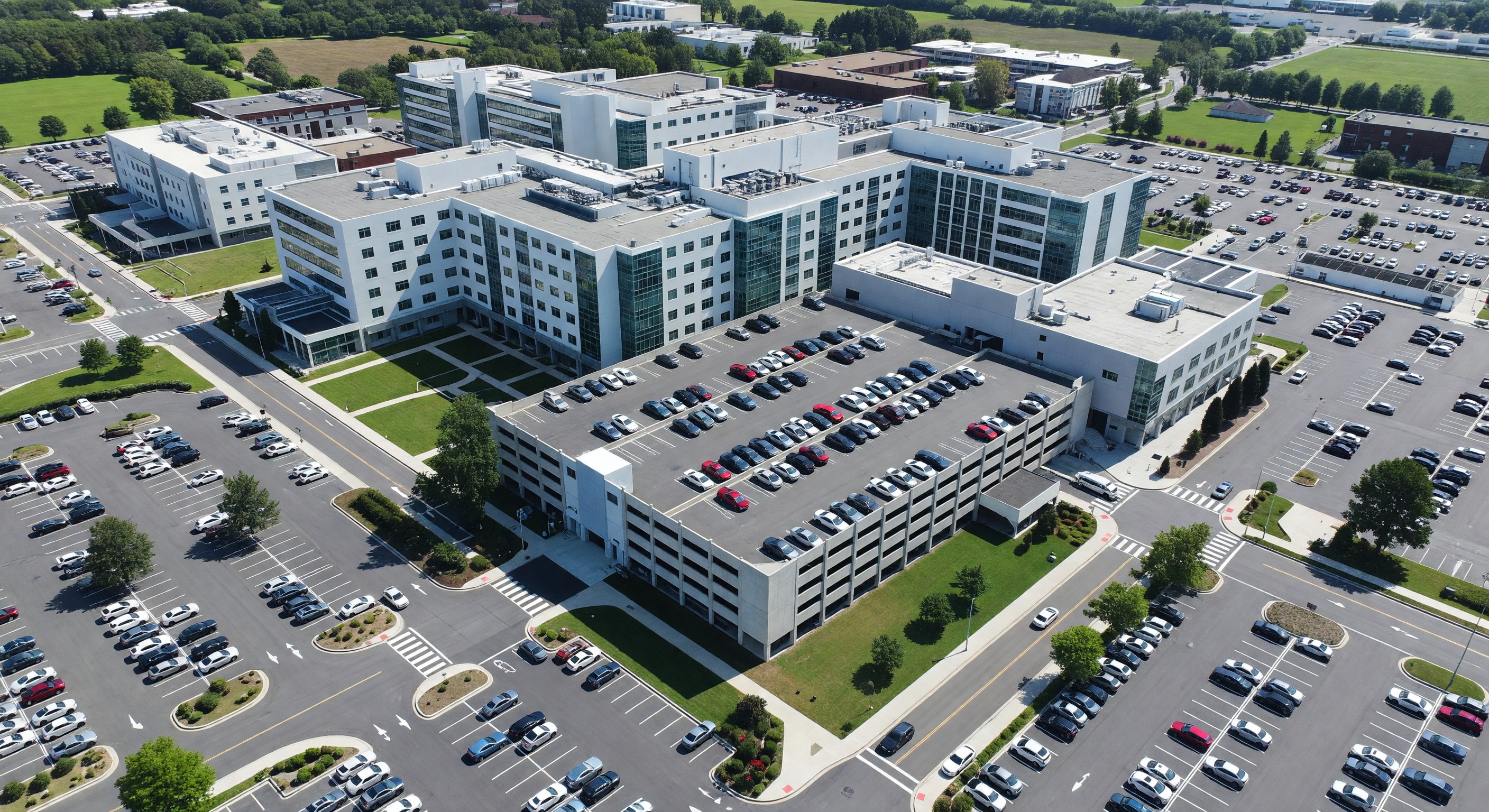 Aerial view of hospital campus with parking structure and surface lots