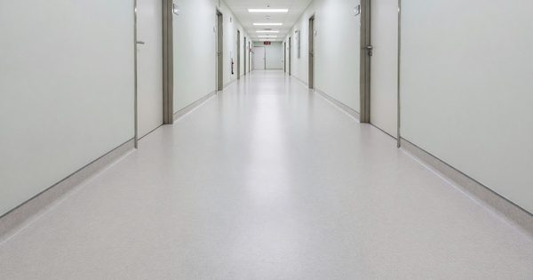 Hospital corridor with seamless resilient flooring and integral cove base
