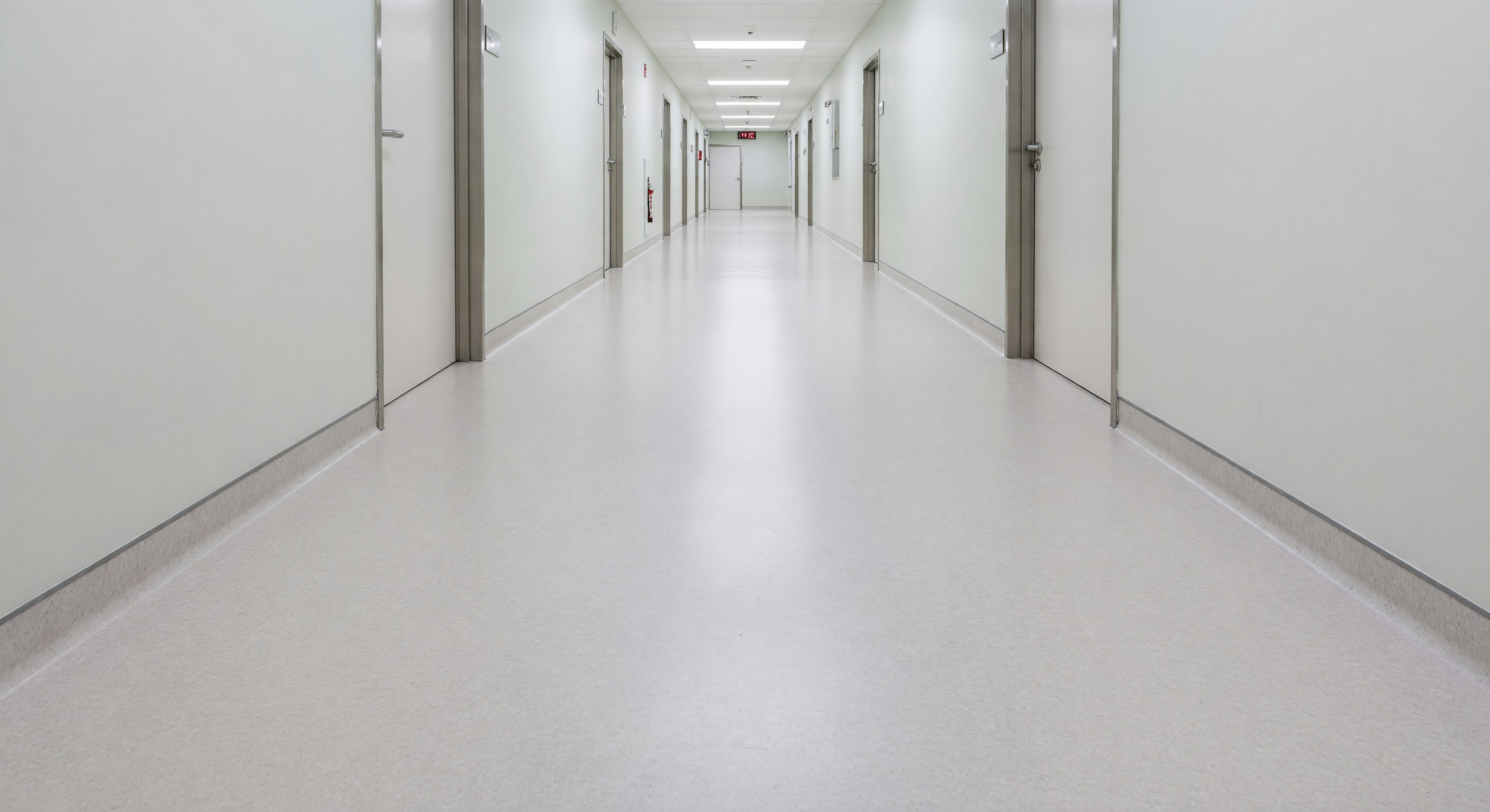 Hospital corridor with seamless resilient flooring and integral cove base