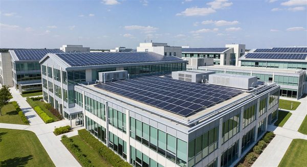 Hospital campus with rooftop solar panels and energy-efficient building systems visible