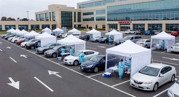 Hospital parking lot converted to drive-through COVID-19 testing and vaccination site