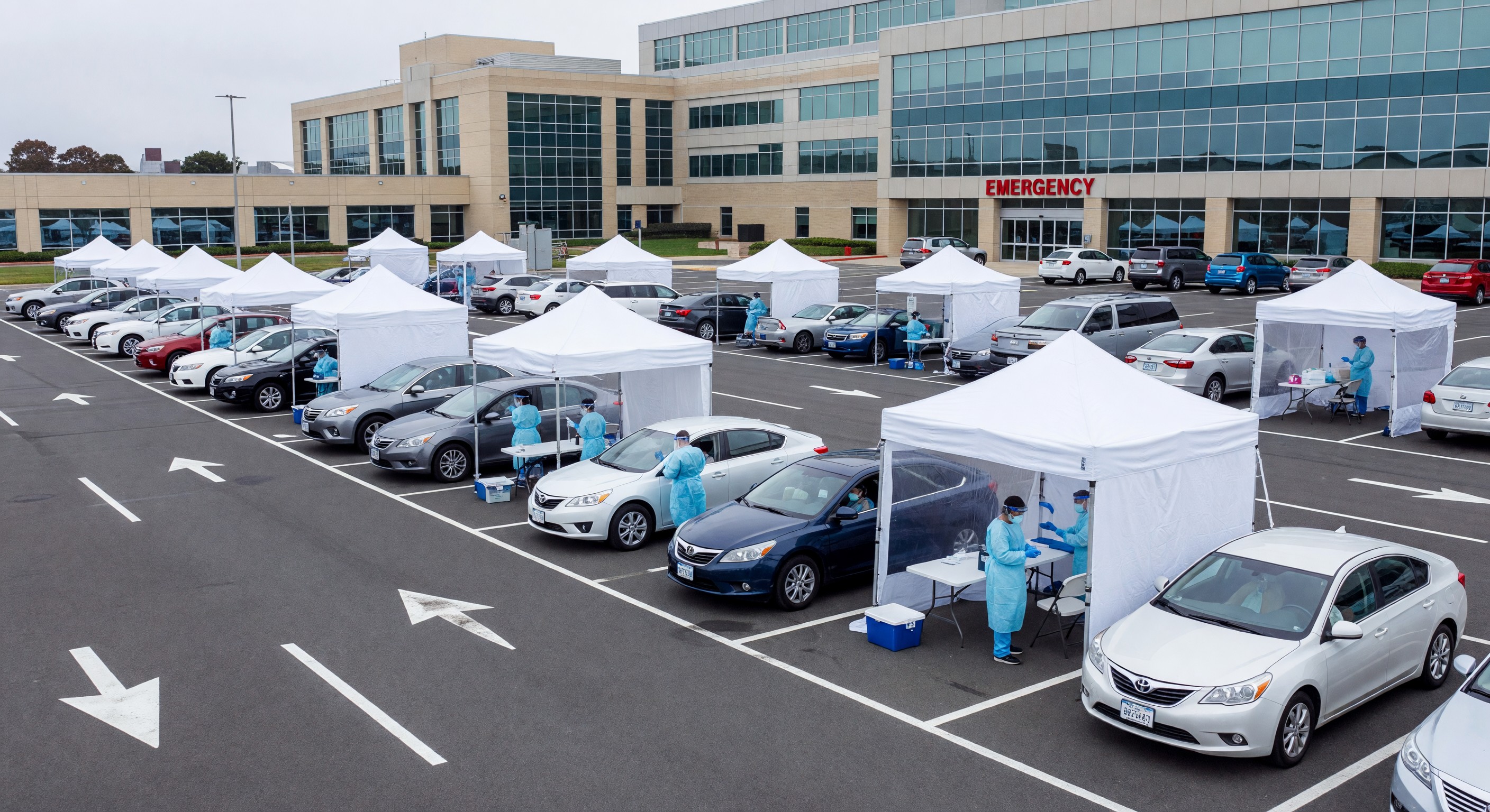 Hospital parking lot converted to drive-through COVID-19 testing and vaccination site