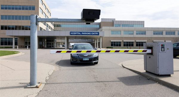 LPR camera mounted at hospital parking entry lane capturing vehicle plate for access control