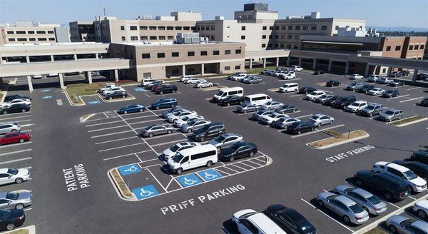 Aerial view of a hospital parking facility with clearly marked patient and staff zones