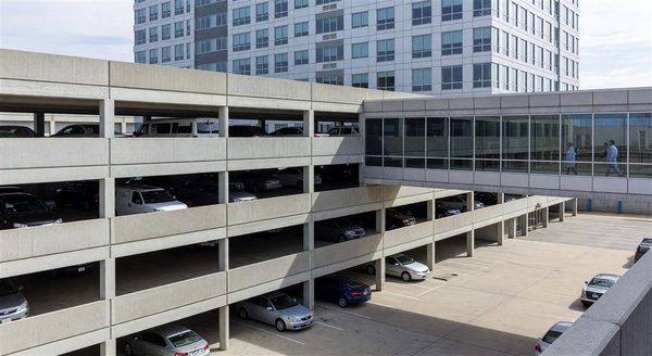 Multi-level hospital parking structure with pedestrian bridge connection to medical building