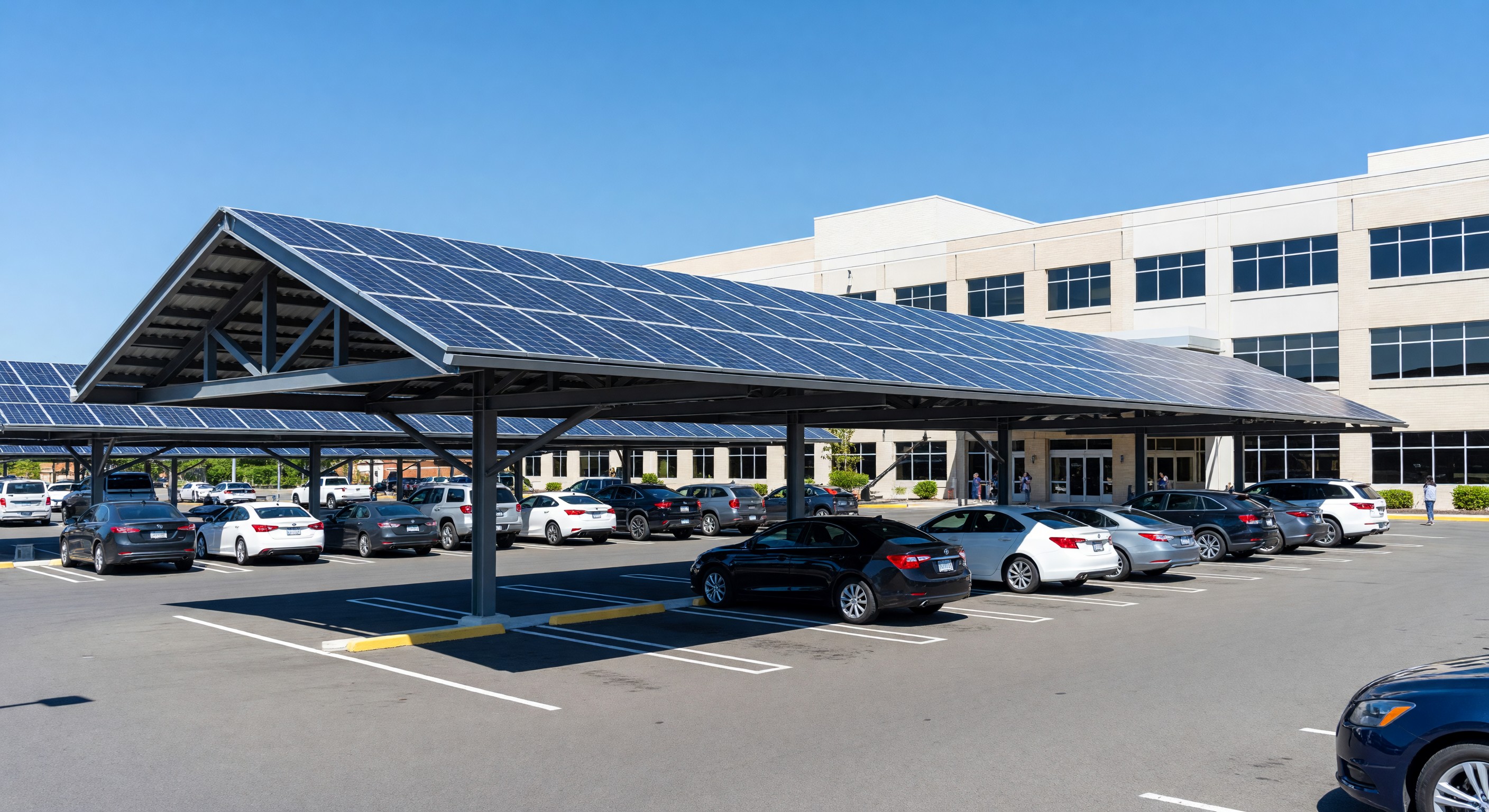 Hospital parking lot with solar carport canopy providing shade and renewable energy generation