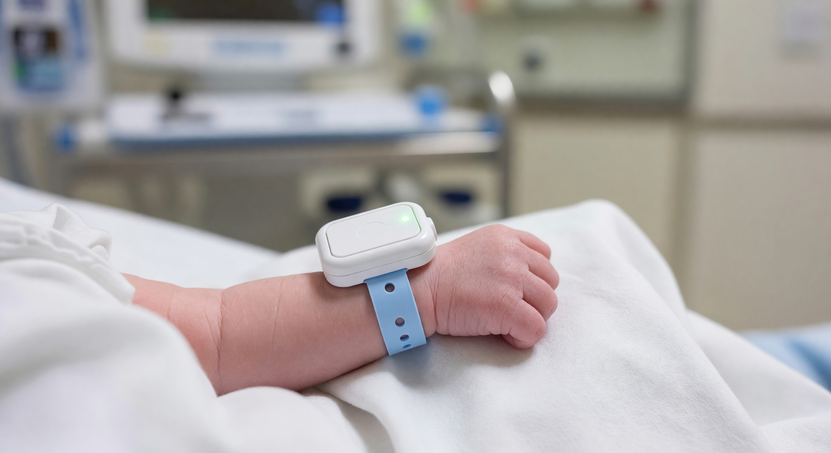 Newborn infant wristband with RTLS security tag in hospital maternity unit