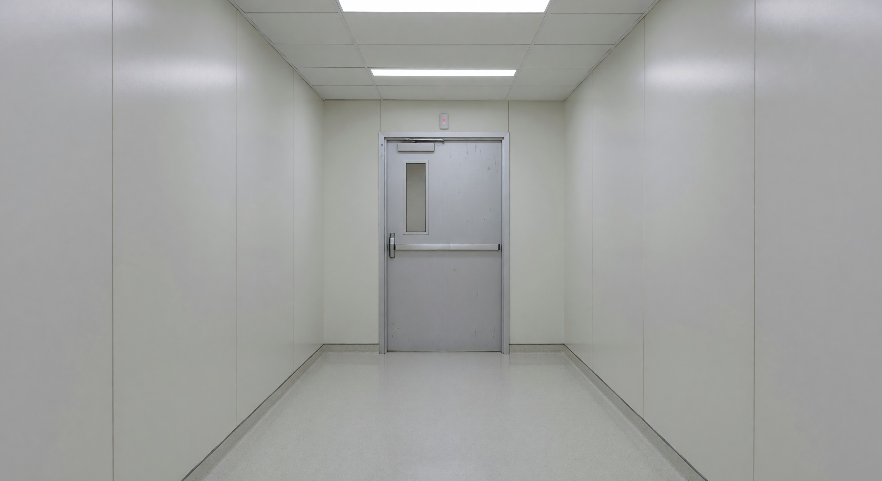 Hospital corridor with controlled exit door and wander management sensor