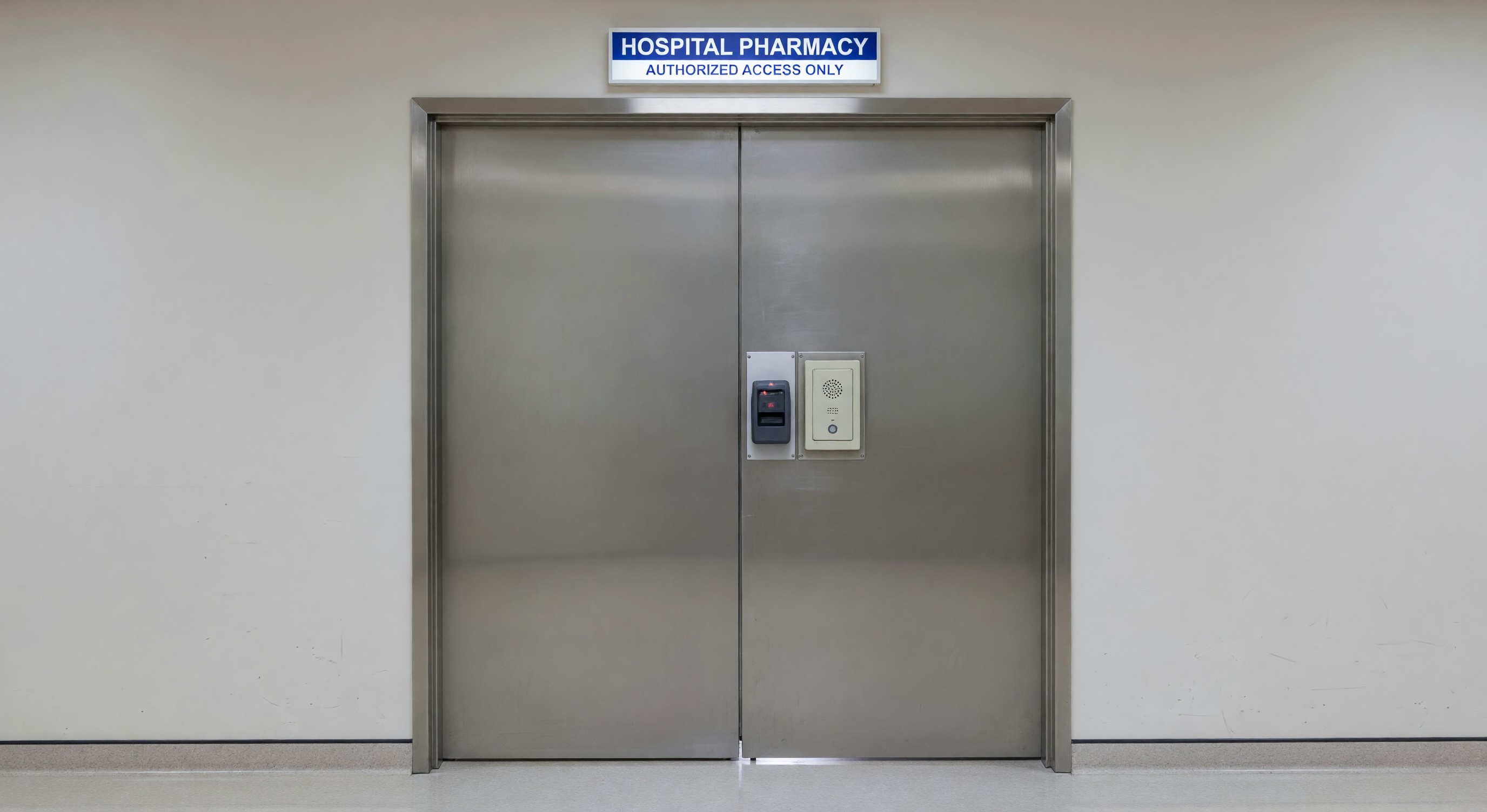 Secured double door entry to hospital pharmacy with card reader and intercom panel