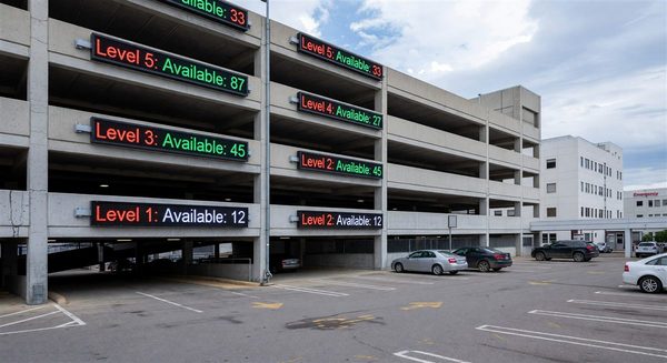 Hospital parking structure with dynamic space availability displays at each level showing available count