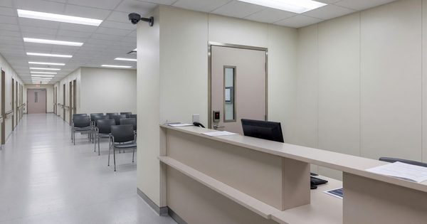 Hospital emergency department reception area with security camera and secure staff access point