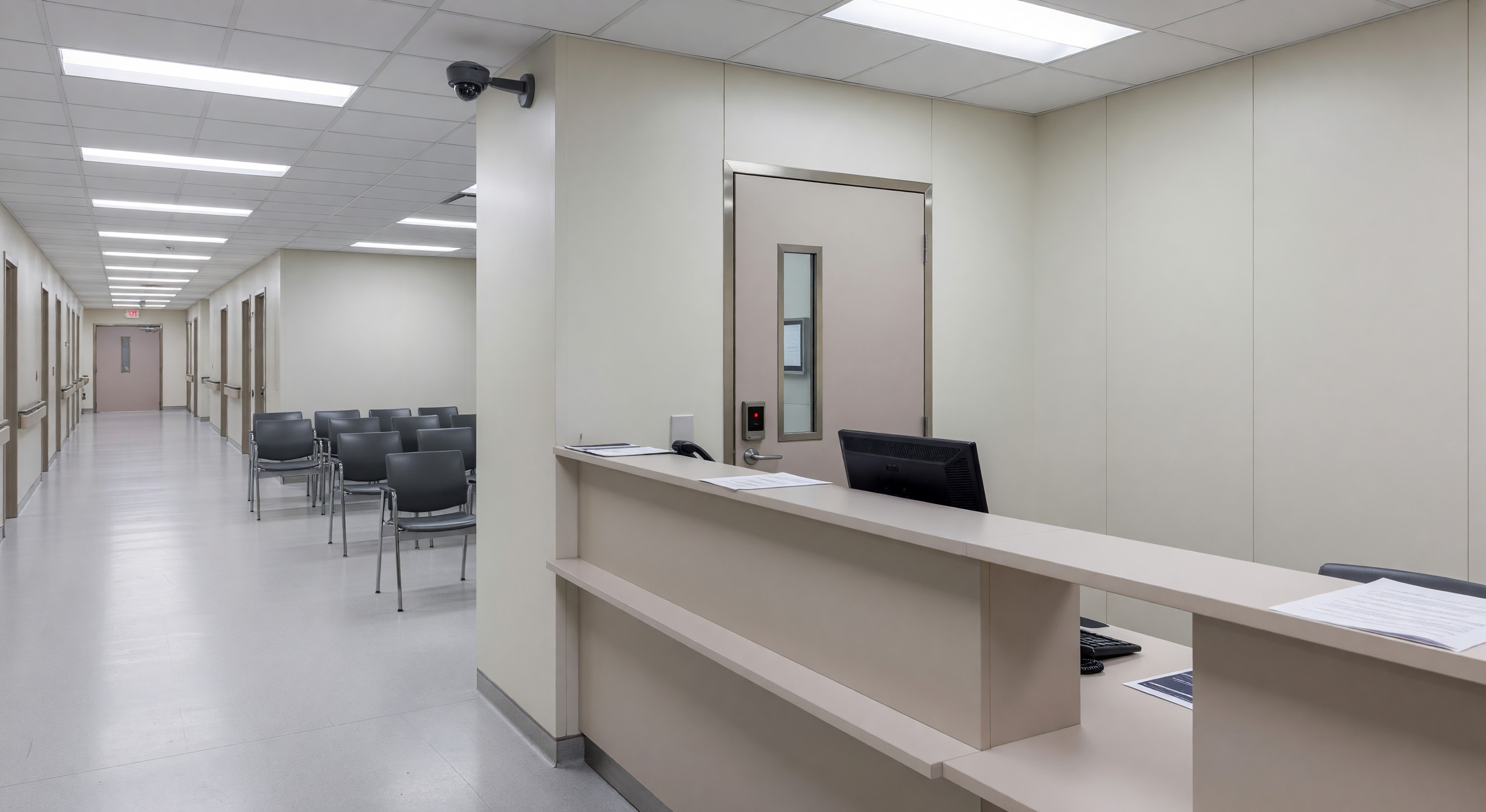 Hospital emergency department reception area with security camera and secure staff access point